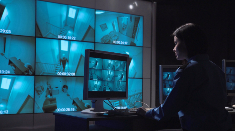 Virtual guard services monitoring center in Singapore with security professional watching multiple CCTV camera feeds on screens